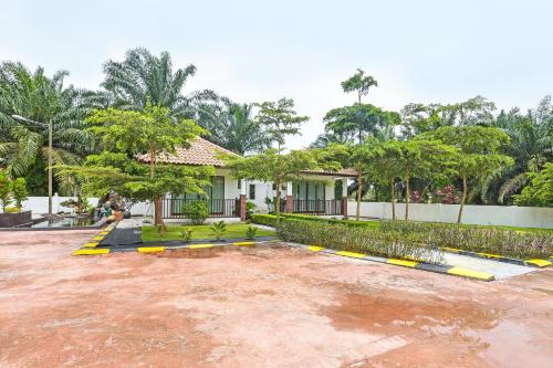 a house with a parking lot in front of it at Hotel O Jentayu Homestay Pontian in Pontian Kecil