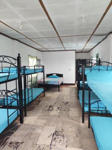 a room with several bunk beds in it at Calishores Beachfront Resort in Morong