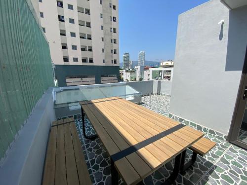 a wooden bench sitting on the roof of a building at MầM Homestay in Quy Nhon