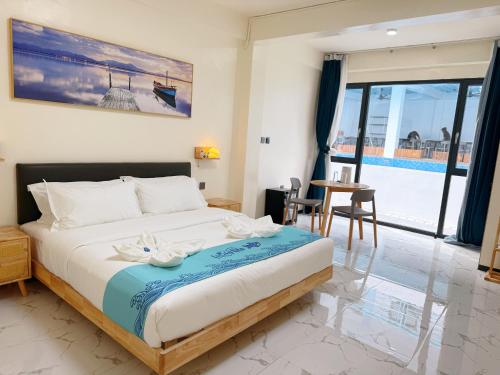 a bedroom with a bed and a view of a pool at LuckyTito Divers Resort Boracay Island in Boracay