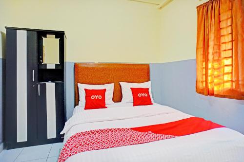 Postel nebo postele na pokoji v ubytování Hotel O Skyview Near Universitas Sumatra Utara ( USU ) Formerly Juma Ciger