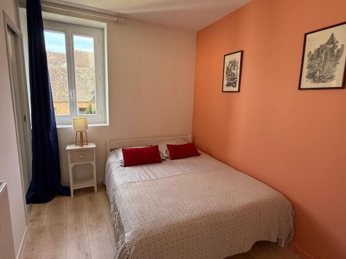 a small bedroom with a bed and a window at Les Appartements Chambon in Sarlat-la-Canéda