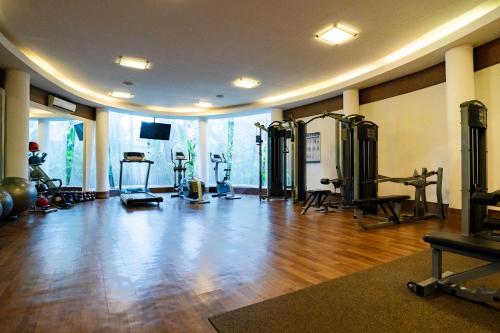 a gym with several treadmills and machines in a room at Gending Kedis Luxury Villas & Spa Estate in Jimbaran