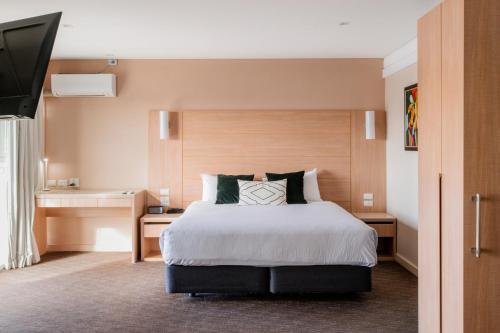 a hotel room with a bed and a television at The Terrace Hotel Adelaide in Adelaide
