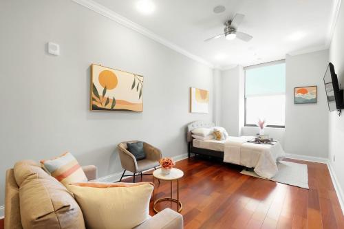a living room with a couch and a table at XL Studio -Deluxe Studio - Pool & Concierge in Philadelphia