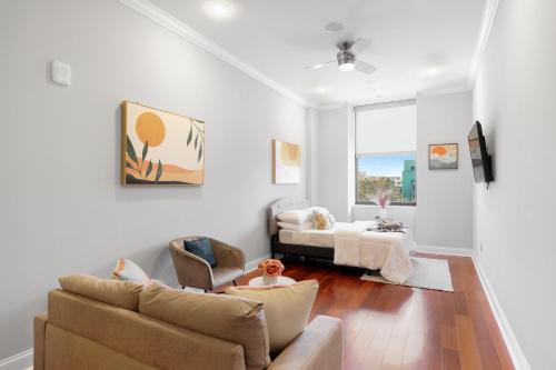 a living room with a couch and a table at XL Studio -Deluxe Studio - Pool & Concierge in Philadelphia