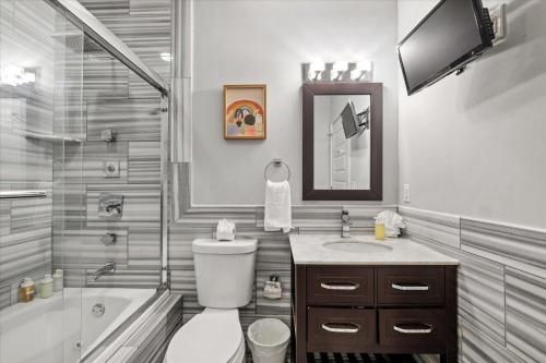 a bathroom with a toilet and a sink and a shower at XL Studio -Deluxe Studio - Pool & Concierge in Philadelphia