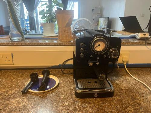 an old camera is sitting on a counter at The Coffee Residences at KINGS MILLENNIUM APARTMENTS, near JKI Airport 3 Bedroom in Nairobi