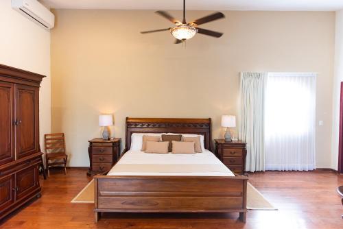 a bedroom with a bed and a ceiling fan at Hacienda San Antonio in Kanasín
