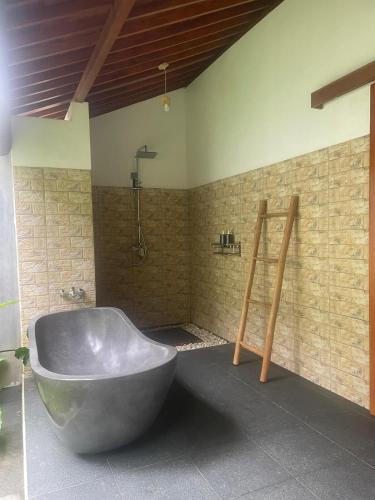 a bathroom with a large tub in a room at Dewaka Villa in Ubud