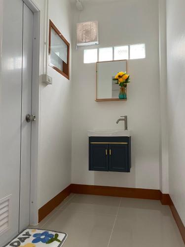 a bathroom with a sink and a mirror at Ct House in Chiang Mai