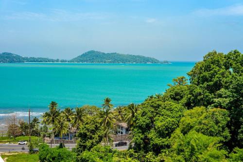 a view of the ocean and palm trees at A New Experience of Private Vacation and Work in Patong in Patong Beach