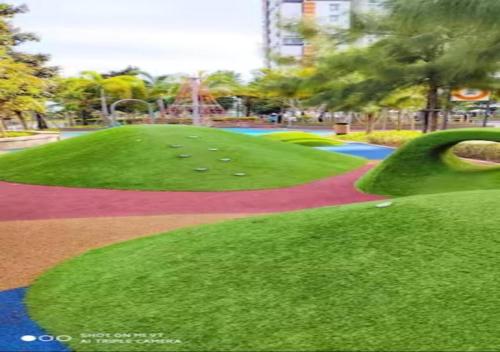 a park with a green hill with golf balls on it at Timurbay Seafront Residences by Nature Home in Kuantan