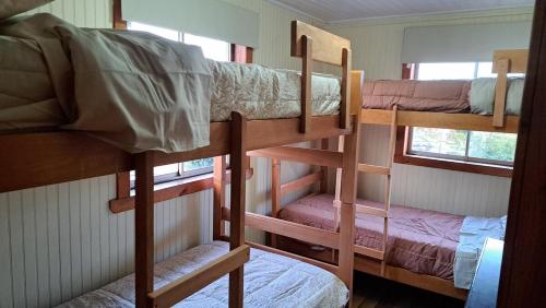 a group of bunk beds in a room at Zenteno Osorno Apartment in Osorno
