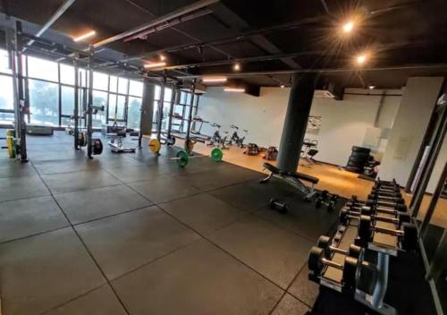 a gym with a large room with treadmills and machines at Timurbay Seafront Residences by Nature Home in Kuantan