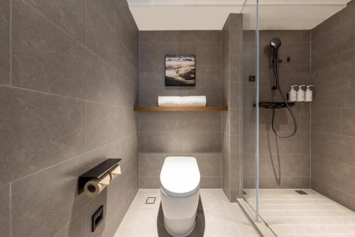 a bathroom with a toilet and a shower at Atour Hotel Guangzhou Railway Station University of Chinese Medicine - Complimentary Self-Service Laundry in Guangzhou