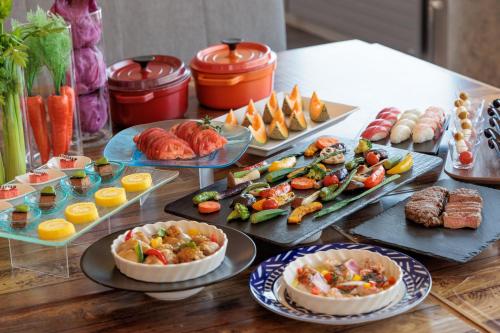 a table with many plates of food on it at Biei Shirogane Onsen Hotel Park Hills in Biei