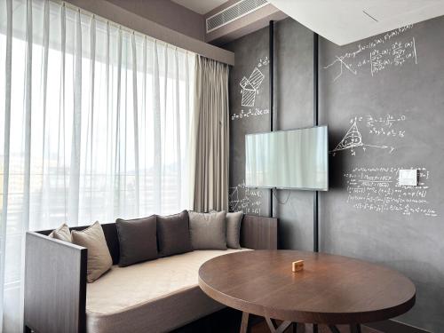 a living room with a couch and a table at Just Sleep - Taipei NTU in Taipei