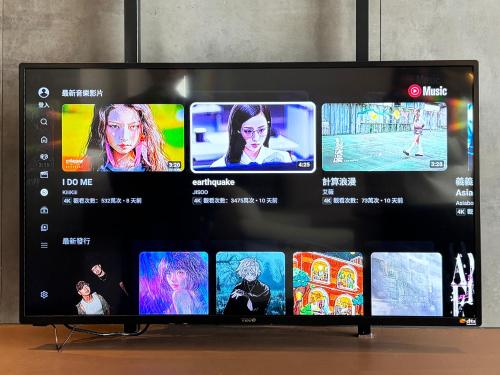 a television screen with a bunch of pictures on it at Just Sleep - Taipei NTU in Taipei