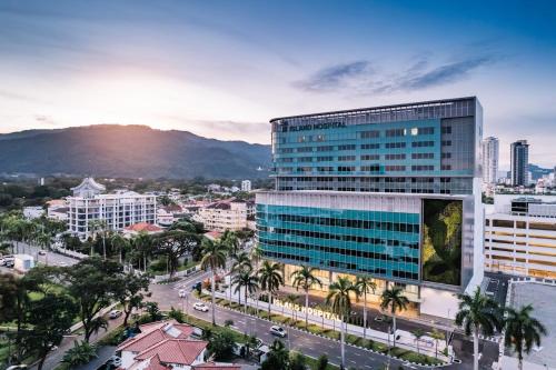 an aerial view of a city with a tall building at TwinTree Kelawai in George Town