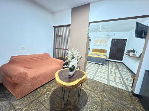 a bedroom with a bed and a table with flowers on it at Casa Guiba 2 Puerto Escondido in Puerto Escondido