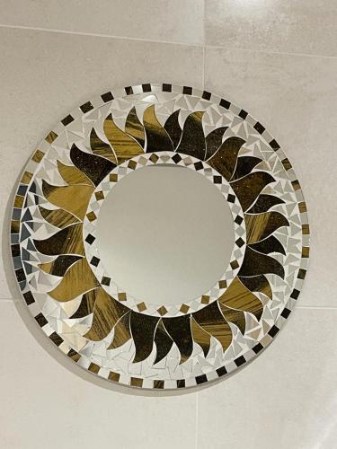 a round mirror on a wall in a room at nuitzen in Boyer
