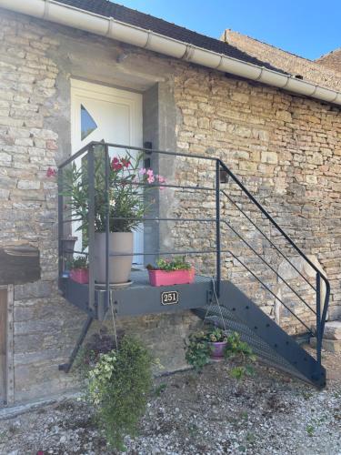 a balcony with two potted plants on a house at nuitzen in Boyer