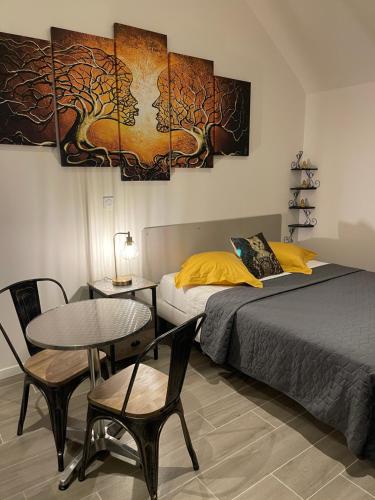 a bedroom with a bed and a table and chairs at nuitzen in Boyer