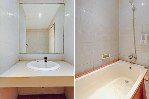 a bathroom with a sink and a bath tub at Collection O Riau Near Trans Studio Bandung Formerly Asteria Hotel in Bandung