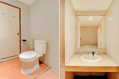 a bathroom with a toilet and a sink at Collection O Riau Near Trans Studio Bandung Formerly Asteria Hotel in Bandung