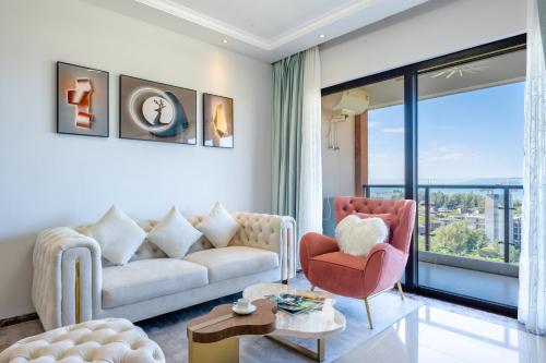 a living room with a couch and a chair at 福湾海涛 in Sanya