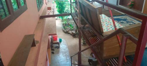 an overhead view of a staircase in a house at East West Farm Homestay in Munnar