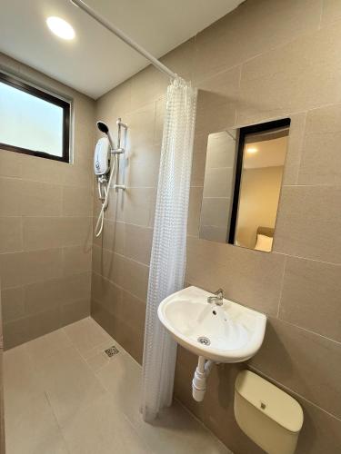 a bathroom with a sink and a shower at TwinTree Kelawai in George Town