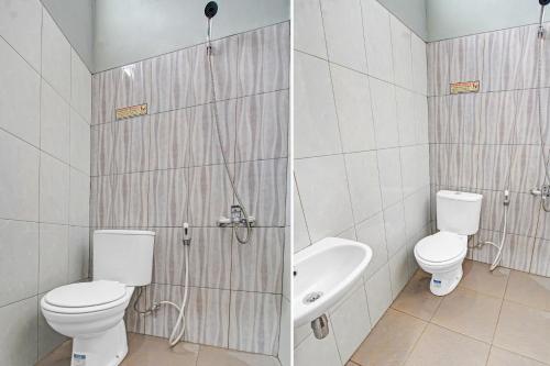 a bathroom with a toilet and a tub and a sink at Hotel O Gm Guest House in Wonogiri