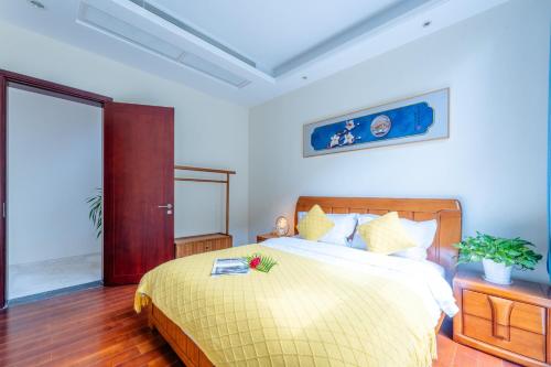 a bedroom with a bed with a book on it at 福湾海涛 in Sanya