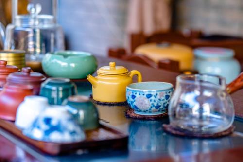 a table with a bunch of dishes and cups on it at 福湾海涛 in Sanya