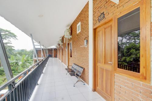 a balcony with two chairs on a building at Hotel O D Kost In Kandri Semarang in Semarang