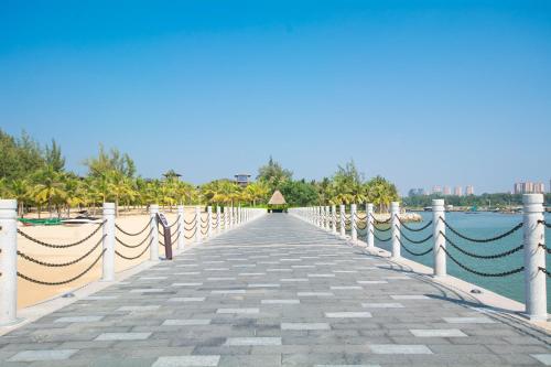 a boardwalk over the water at a resort at 福湾海涛 in Sanya
