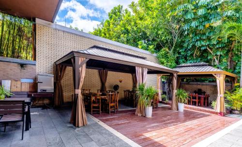 a pavilion with a table and chairs on a wooden deck at 福湾海涛 in Sanya