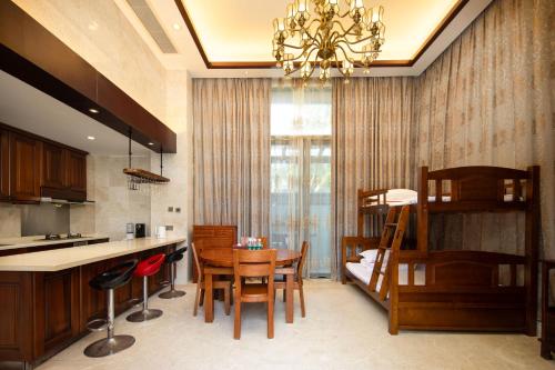 a kitchen and dining room with a table and chairs at 福湾海涛 in Sanya