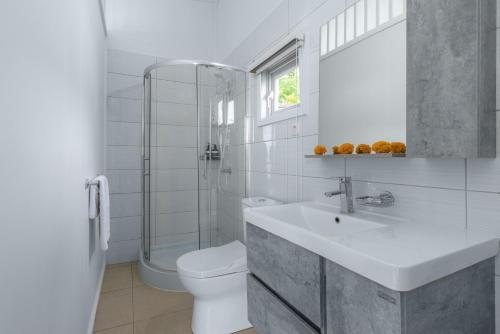 a white bathroom with a sink and a toilet at Seaview Private Villas in Nusa Lembongan