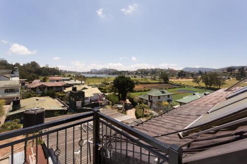 a view of a town from a balcony at Hotel Grand Turf By GSP in Nuwara Eliya