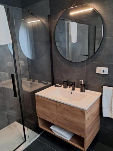a bathroom with a sink and a mirror at - NumberZ - Rooms Apartments and Suites with Wi-Fi and AC in Borgo Isonzo