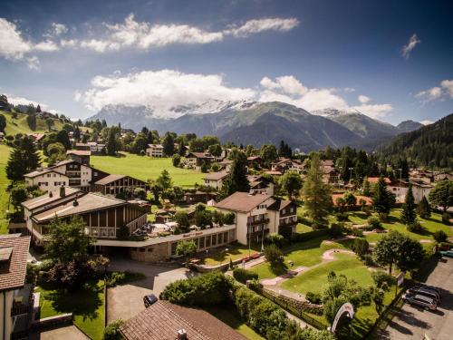 an aerial view of a village in the mountains at Hotel Sport Klosters in Klosters