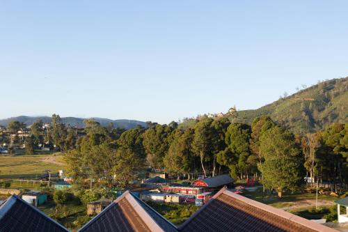 an aerial view of a village with a mountain at Hotel Grand Turf By GSP in Nuwara Eliya