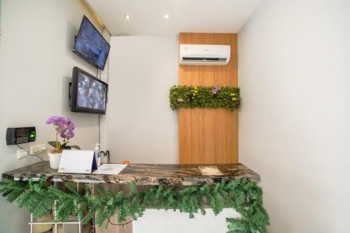 a room with a counter with flowers on the wall at Collection O Millenium Inn 2 in Medan