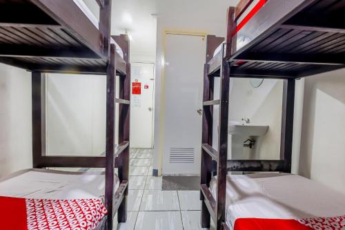 a room with two bunk beds and a sink at Metro Deluxe Residences in Manila