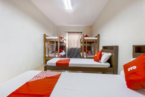 two beds in a room with two bunk beds at Metro Deluxe Residences in Manila