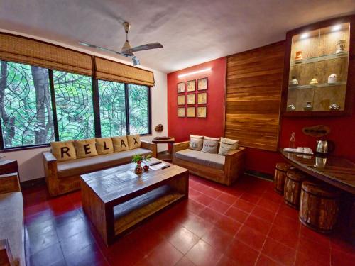 a living room with a couch and a table at Tathastu Pench in Khawāsa