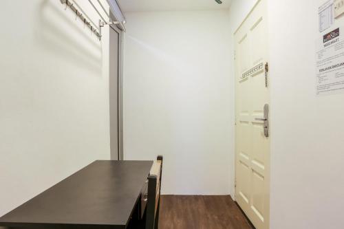 a dining room with a table and a door at Hotel O Kl2f Rest & Go in Shah Alam